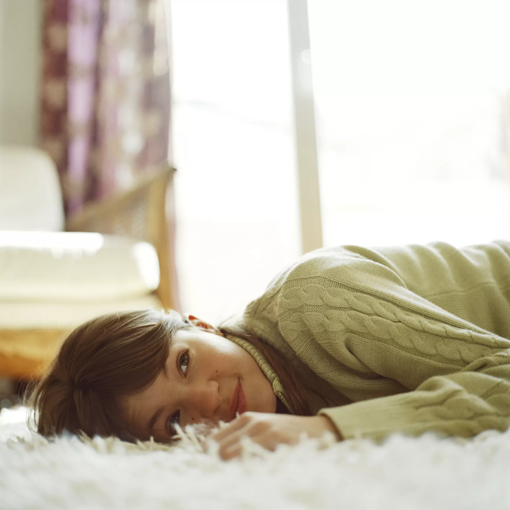 Girl lying on soft comfortable carpet